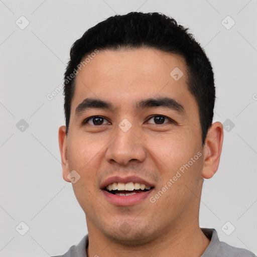 Joyful latino young-adult male with short  black hair and brown eyes