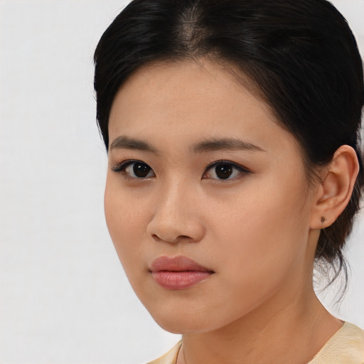 Joyful asian young-adult female with medium  black hair and brown eyes