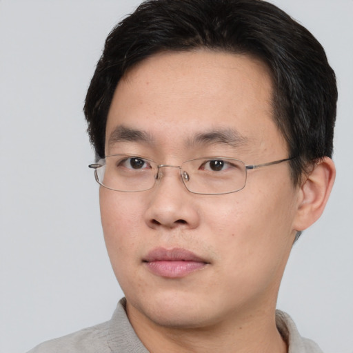 Neutral asian young-adult male with short  brown hair and brown eyes