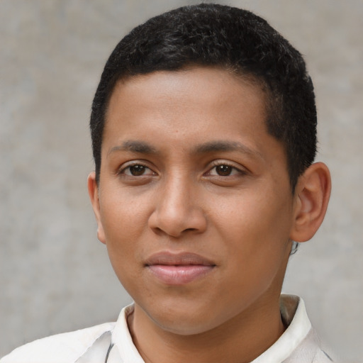 Joyful latino young-adult male with short  brown hair and brown eyes