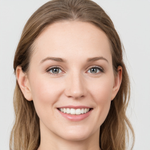 Joyful white young-adult female with long  brown hair and grey eyes