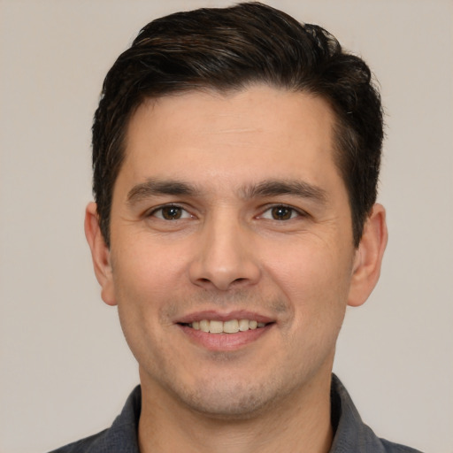 Joyful white young-adult male with short  brown hair and brown eyes