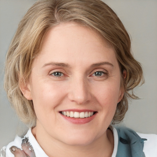 Joyful white young-adult female with medium  brown hair and blue eyes