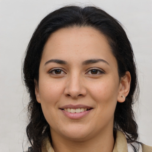 Joyful latino young-adult female with medium  brown hair and brown eyes