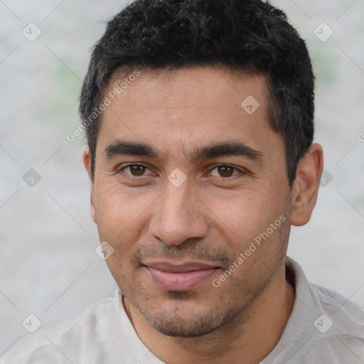 Joyful white young-adult male with short  black hair and brown eyes