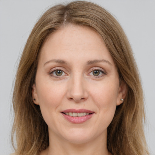 Joyful white adult female with medium  brown hair and grey eyes