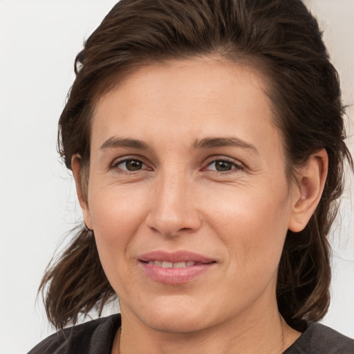 Joyful white adult female with medium  brown hair and brown eyes