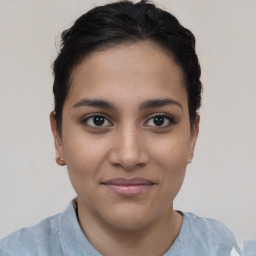 Joyful latino young-adult female with short  brown hair and brown eyes