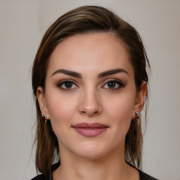 Joyful white young-adult female with medium  brown hair and brown eyes