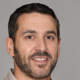 Joyful white adult male with short  brown hair and brown eyes