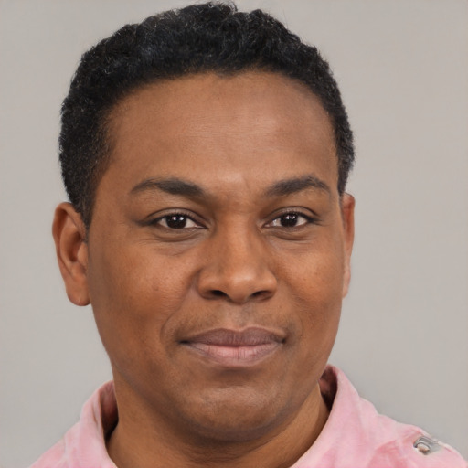 Joyful latino adult male with short  black hair and brown eyes