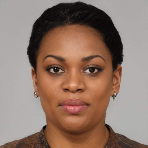 Joyful black young-adult female with short  black hair and brown eyes
