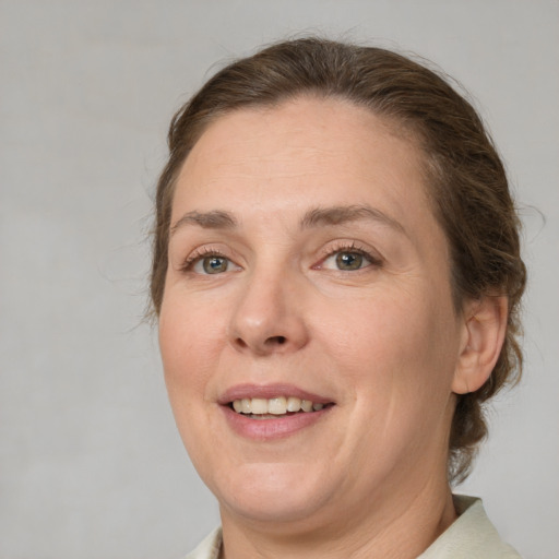 Joyful white adult female with medium  brown hair and brown eyes