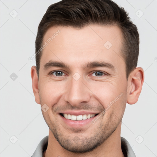 Joyful white young-adult male with short  brown hair and brown eyes