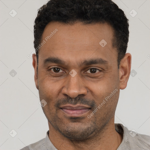 Joyful latino adult male with short  black hair and brown eyes