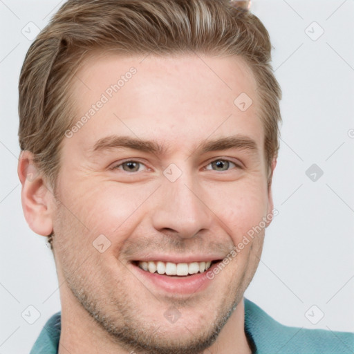 Joyful white young-adult male with short  brown hair and grey eyes