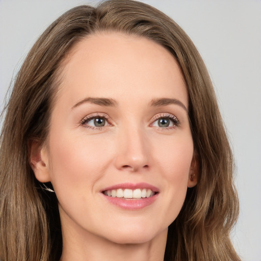 Joyful white young-adult female with long  brown hair and grey eyes