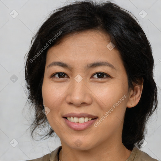 Joyful asian adult female with medium  brown hair and brown eyes