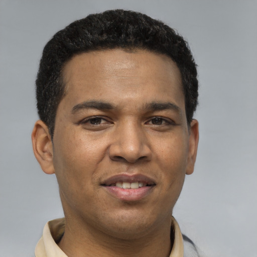 Joyful latino young-adult male with short  brown hair and brown eyes