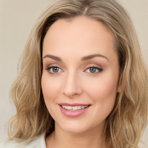 Joyful white young-adult female with long  brown hair and green eyes