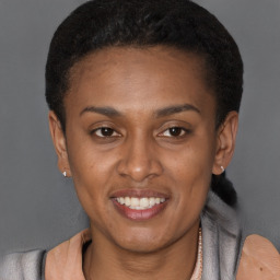 Joyful latino young-adult female with short  brown hair and brown eyes