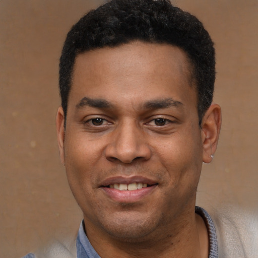 Joyful latino young-adult male with short  black hair and brown eyes