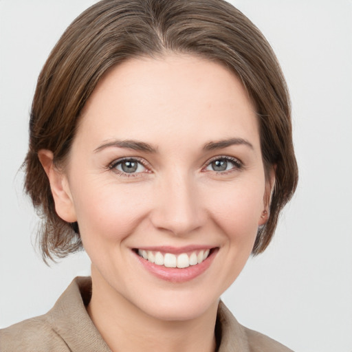 Joyful white young-adult female with medium  brown hair and grey eyes