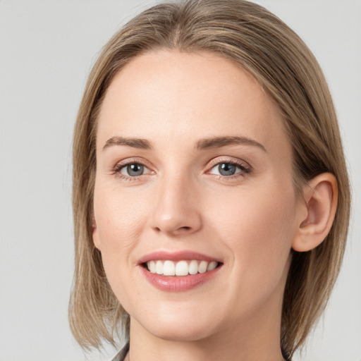 Joyful white young-adult female with medium  brown hair and blue eyes