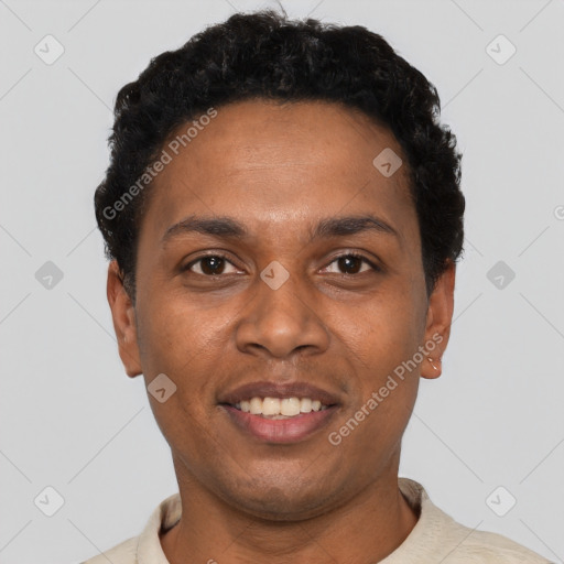 Joyful black young-adult male with short  black hair and brown eyes