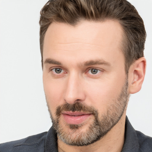 Joyful white adult male with short  brown hair and brown eyes