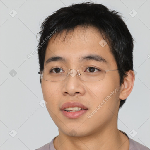 Joyful asian young-adult male with short  black hair and brown eyes