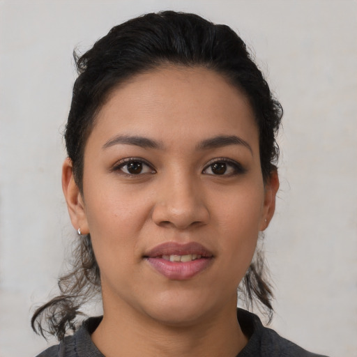 Joyful latino young-adult female with medium  black hair and brown eyes