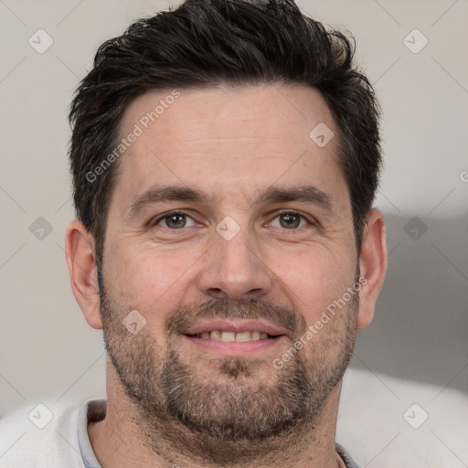 Joyful white adult male with short  brown hair and brown eyes