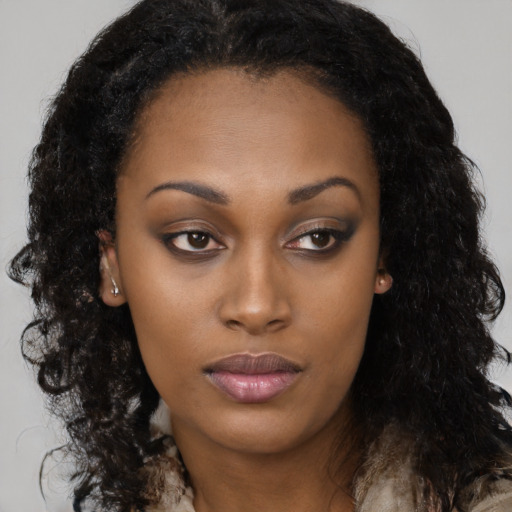 Neutral black young-adult female with long  brown hair and brown eyes