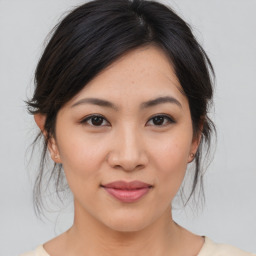 Joyful asian young-adult female with medium  brown hair and brown eyes