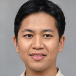 Joyful asian young-adult male with short  brown hair and brown eyes