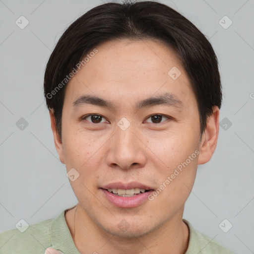 Joyful asian young-adult male with short  brown hair and brown eyes