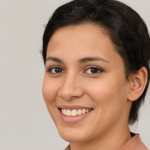 Joyful white young-adult female with medium  brown hair and brown eyes