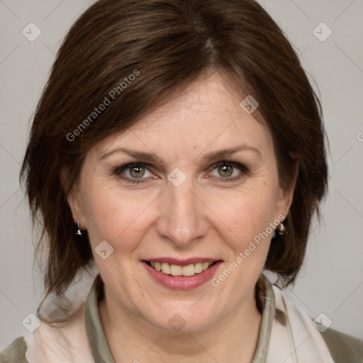 Joyful white adult female with medium  brown hair and grey eyes