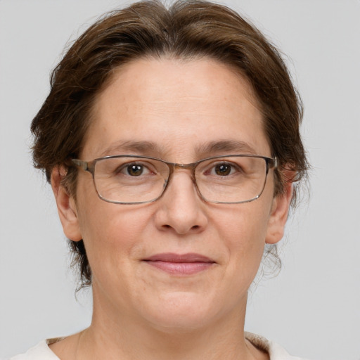 Joyful white adult female with medium  brown hair and grey eyes