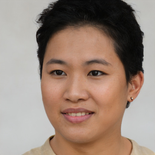 Joyful asian young-adult female with short  brown hair and brown eyes