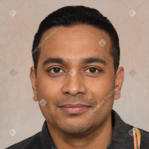 Joyful latino young-adult male with short  black hair and brown eyes