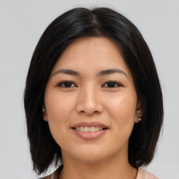 Joyful asian young-adult female with medium  black hair and brown eyes