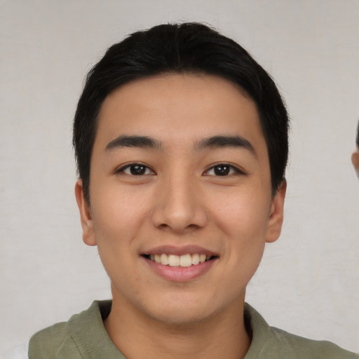 Joyful asian young-adult male with short  black hair and brown eyes