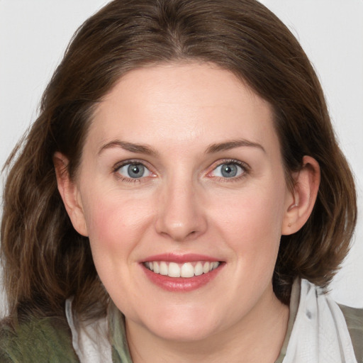 Joyful white young-adult female with medium  brown hair and blue eyes