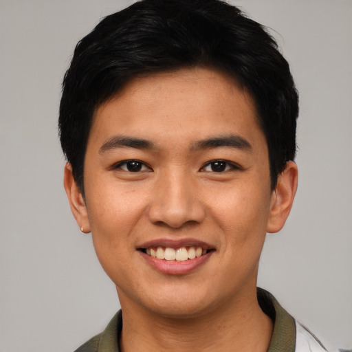 Joyful asian young-adult male with short  black hair and brown eyes