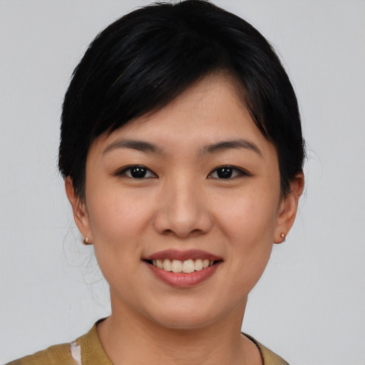 Joyful asian young-adult female with short  black hair and brown eyes