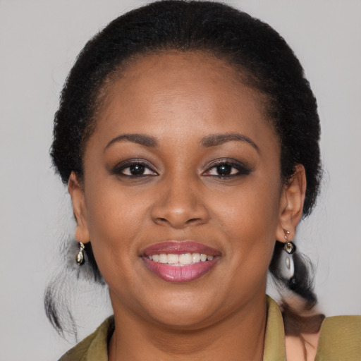 Joyful black young-adult female with medium  brown hair and brown eyes
