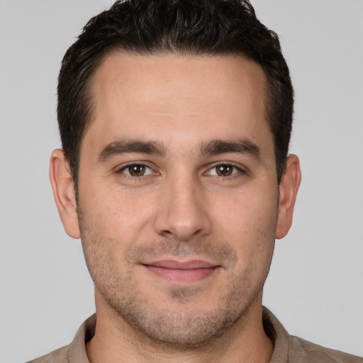 Joyful white young-adult male with short  brown hair and brown eyes