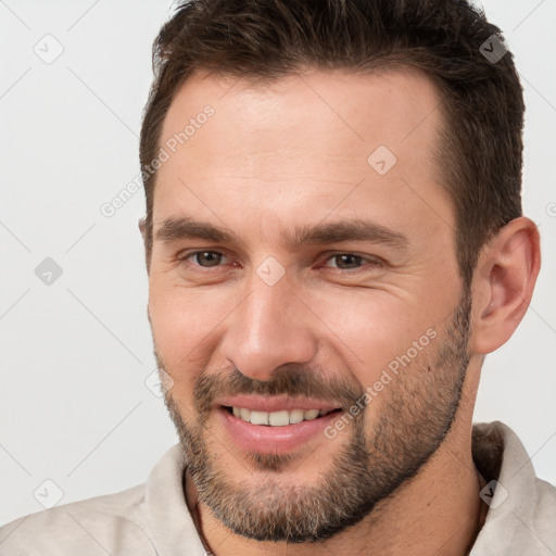 Joyful white young-adult male with short  brown hair and brown eyes